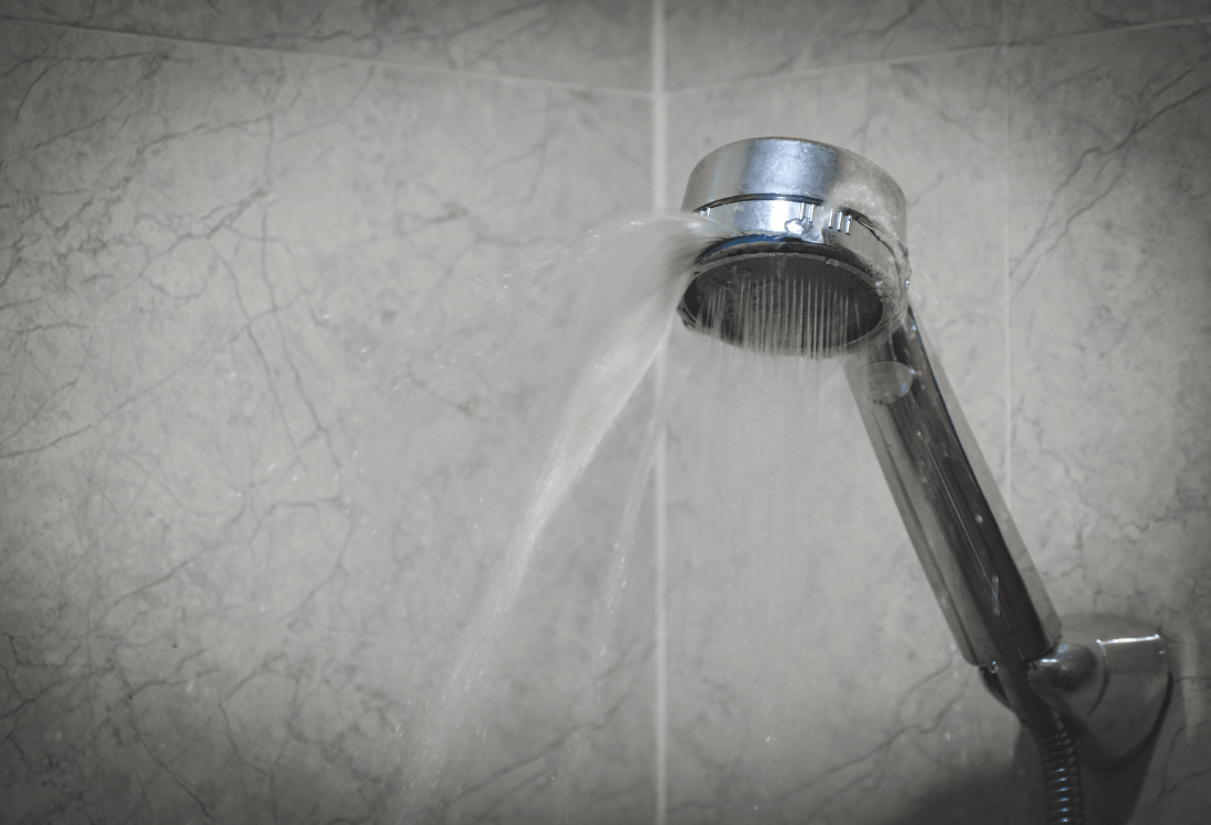 A Damaged Shower Head Leaking Water 