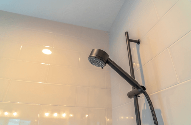 A shower head in a student bathroom demonstrating why you should start planning for next year's university bathroom refit.