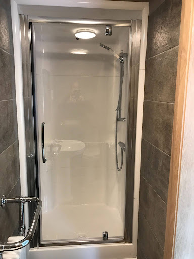 Modern walk-in shower with easy-clean wall panels showcasing practical ways to make a shower more sustainable in contemporary bathroom design.