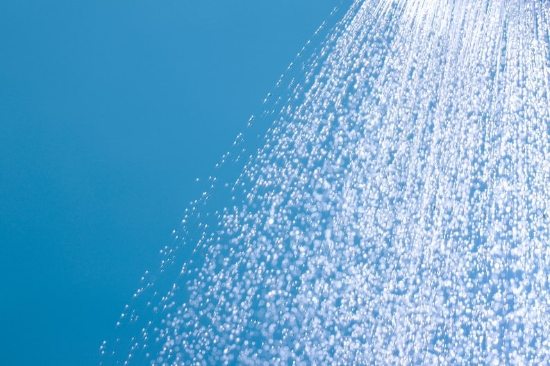 A spray of cold shower water, helping people stay cool in the summer.