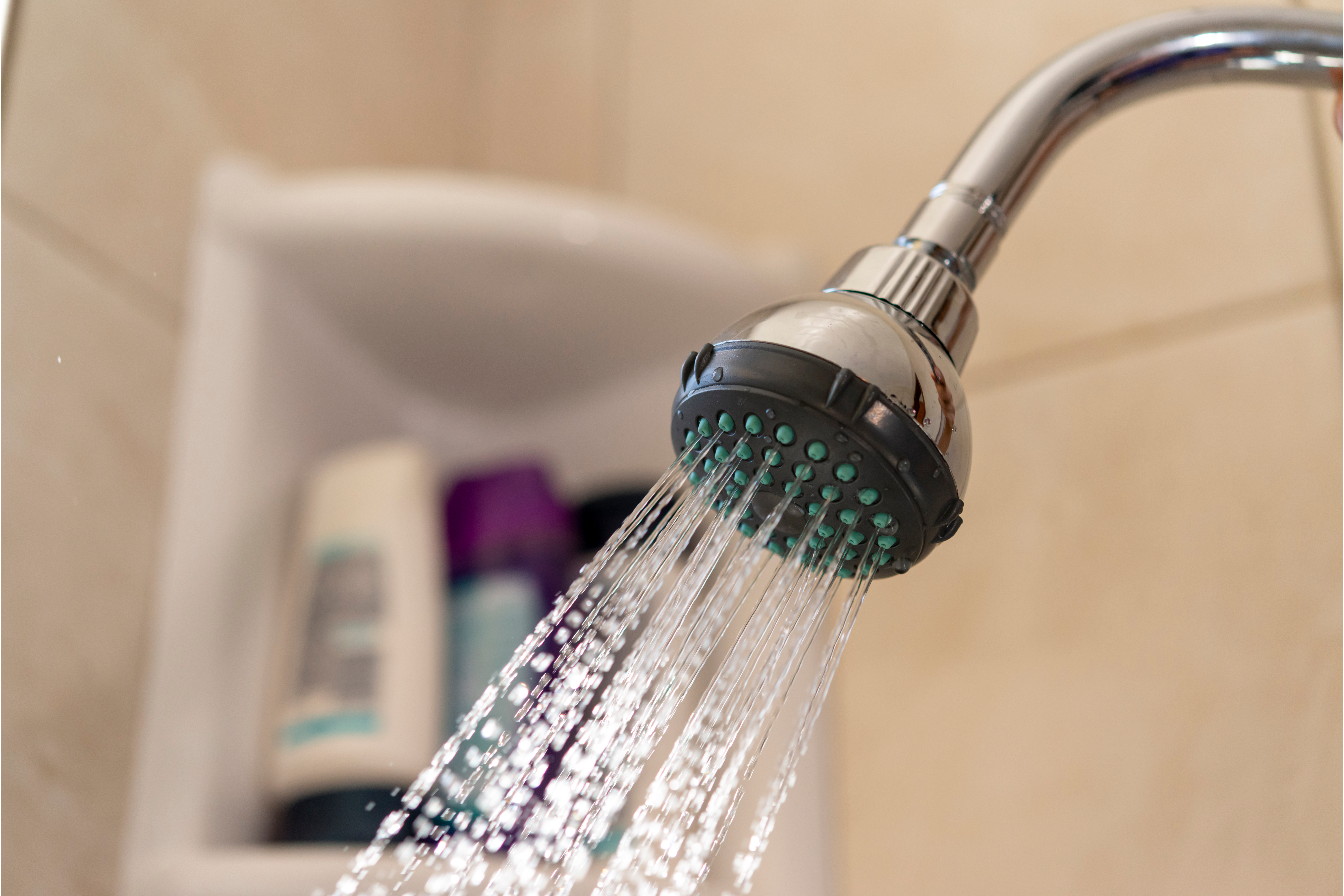 close up of water coming out of shower head to show if water cuts are likely in the uk